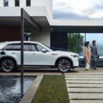 A Mazda PHEV charging in the driveway