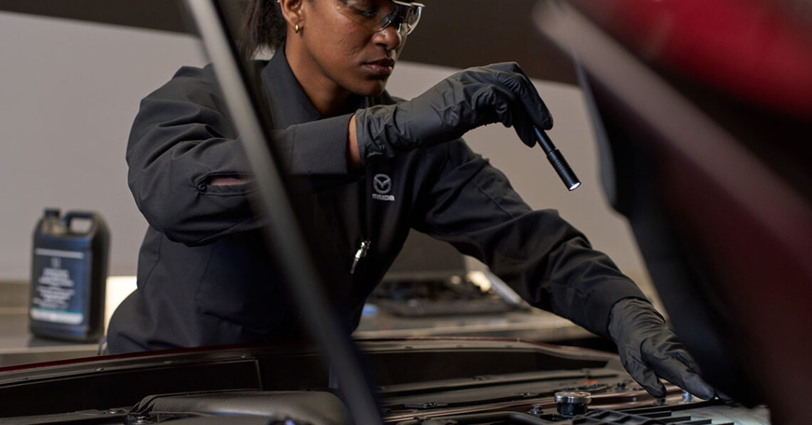 Mazda service technician prepping a car for winter